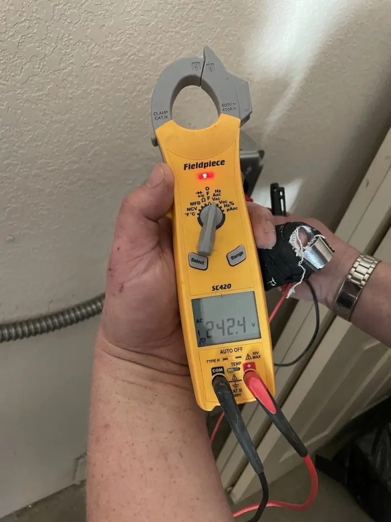 Voltage testing with clamp meter during Generator Installation in Malibu